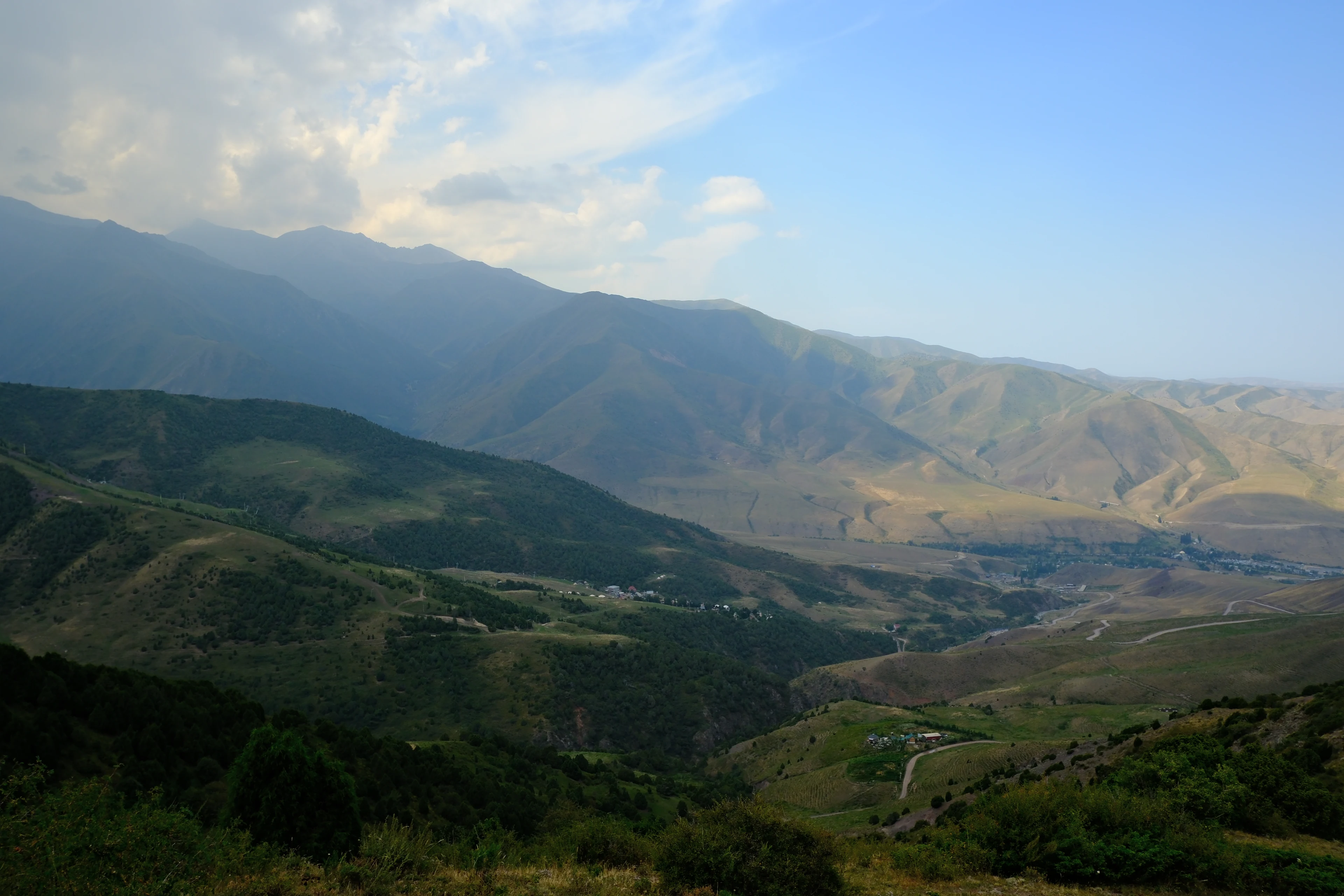 A broad panorama across the valleys and hills of the Alamedin area.