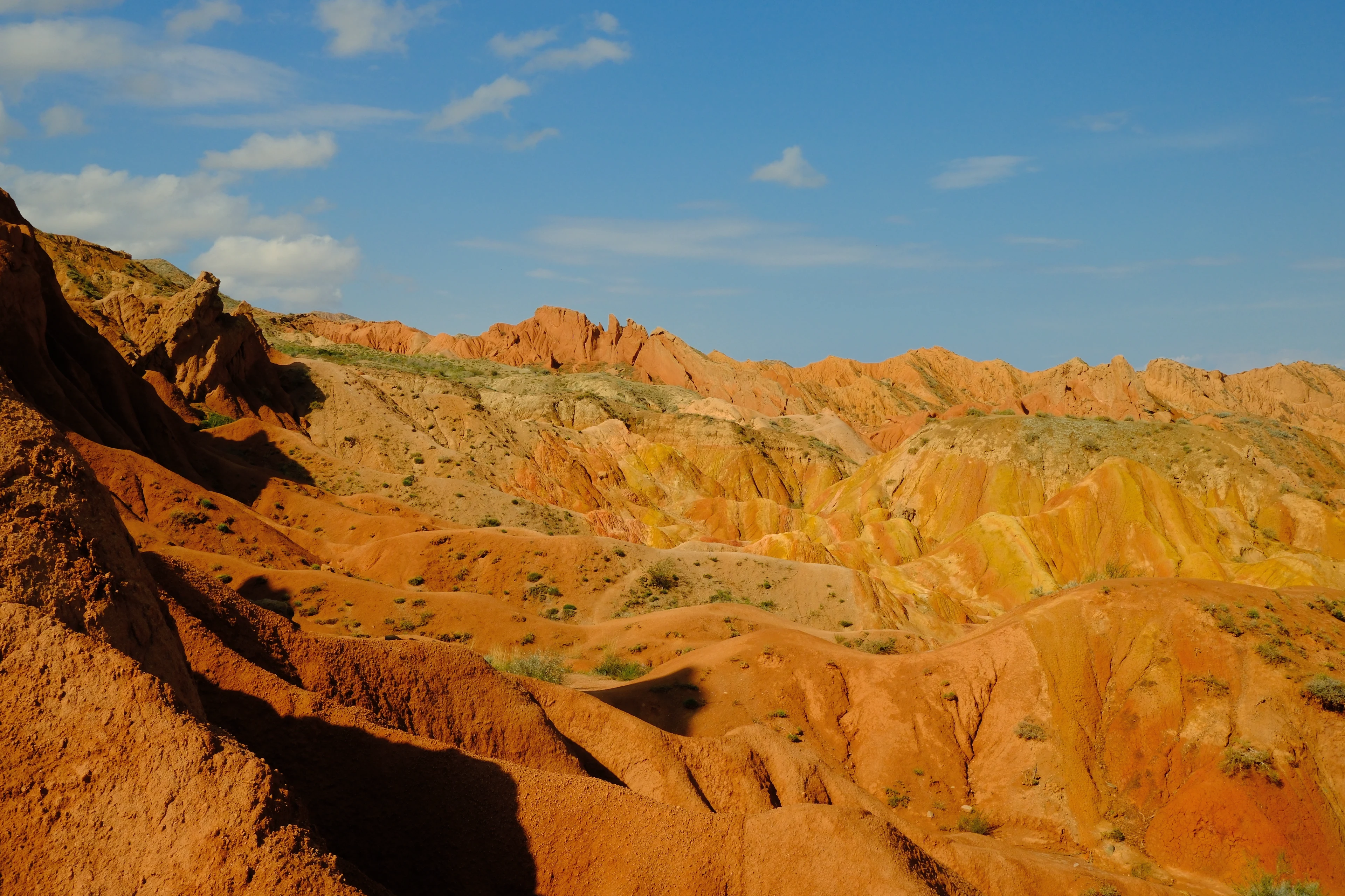 Sunlit gullies and golden sandstone layers in Skazka Canyon.