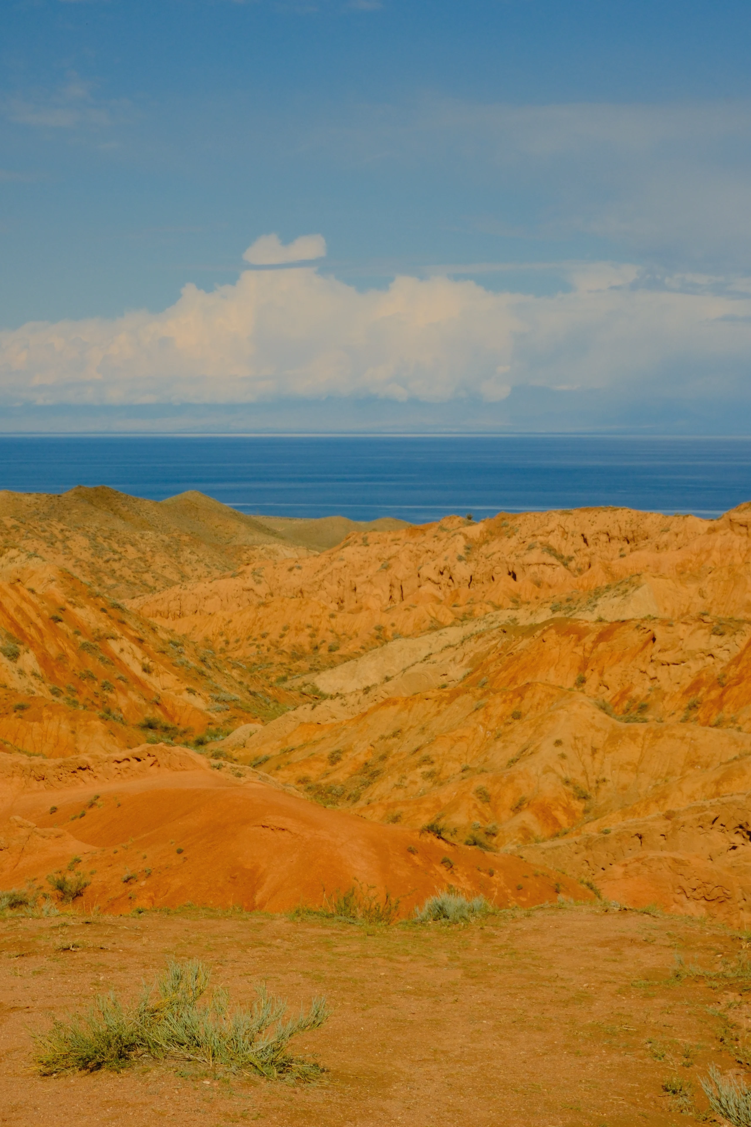 The blue waters of Issyk-Kul beyond the sandstone of Skazka Canyon.