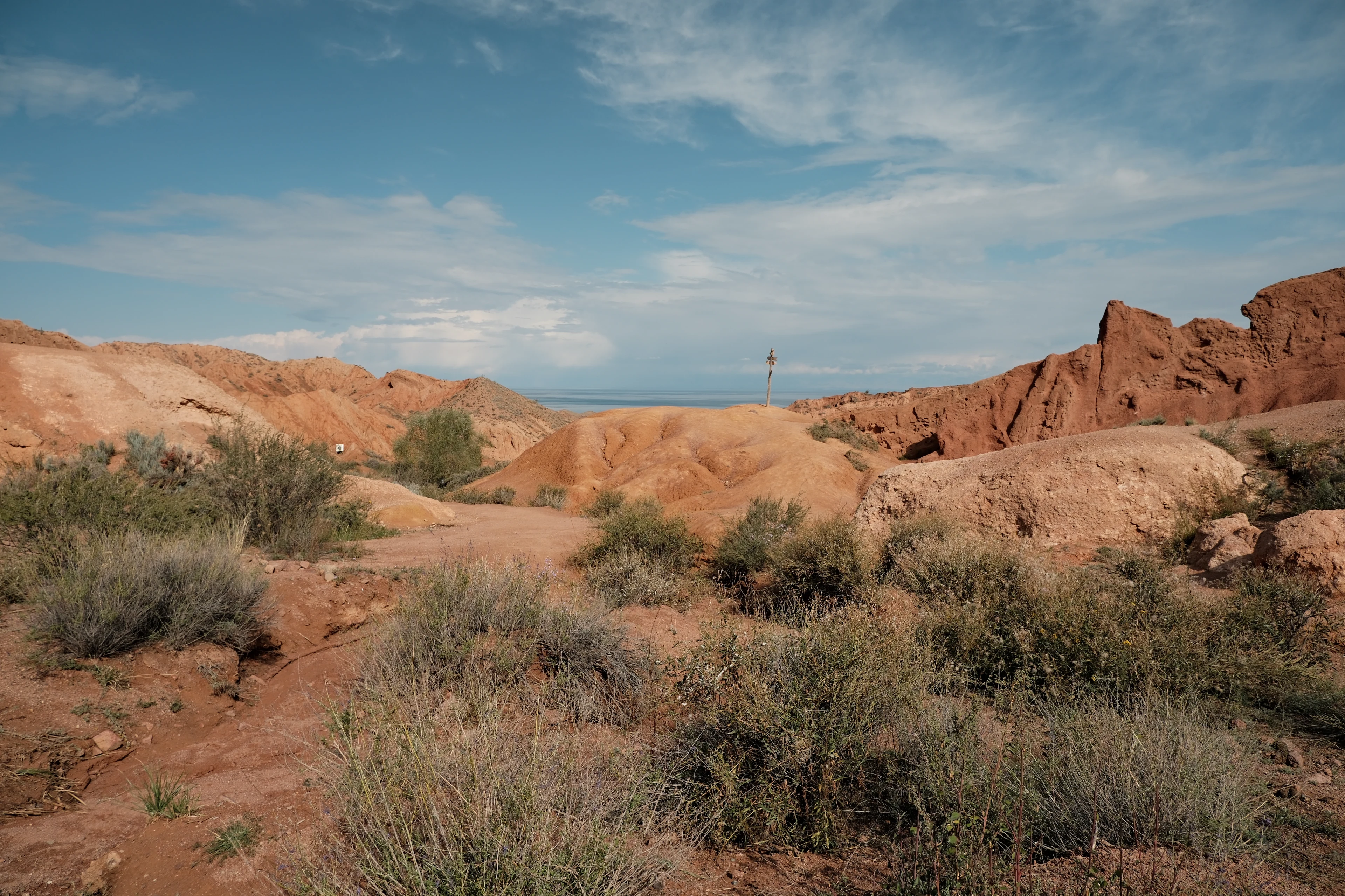 Low sandstone ridges and an open view towards Issyk-Kul in Skazka Canyon.