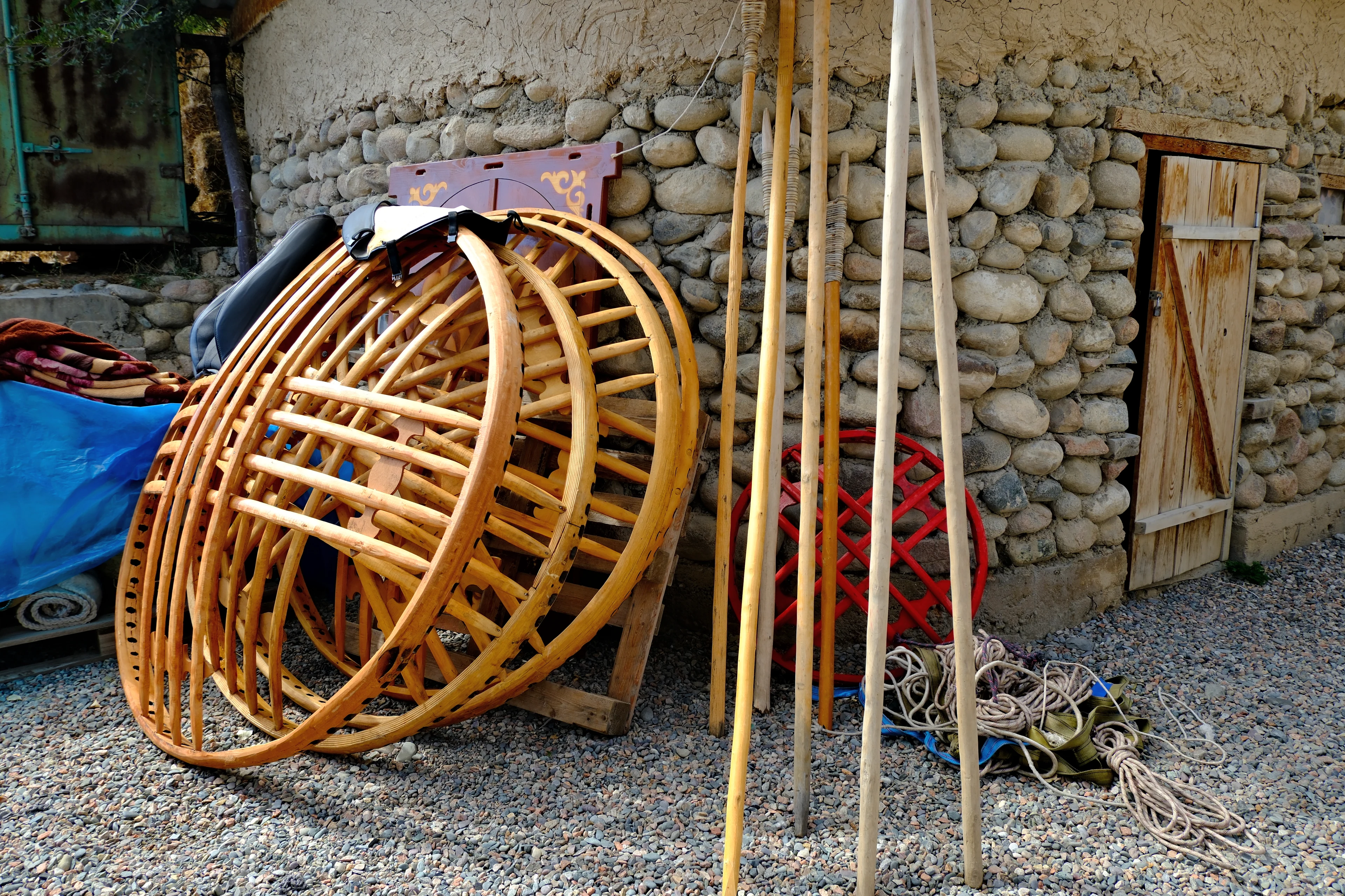 Wooden roof rings and poles prepared for assembling a yurt.