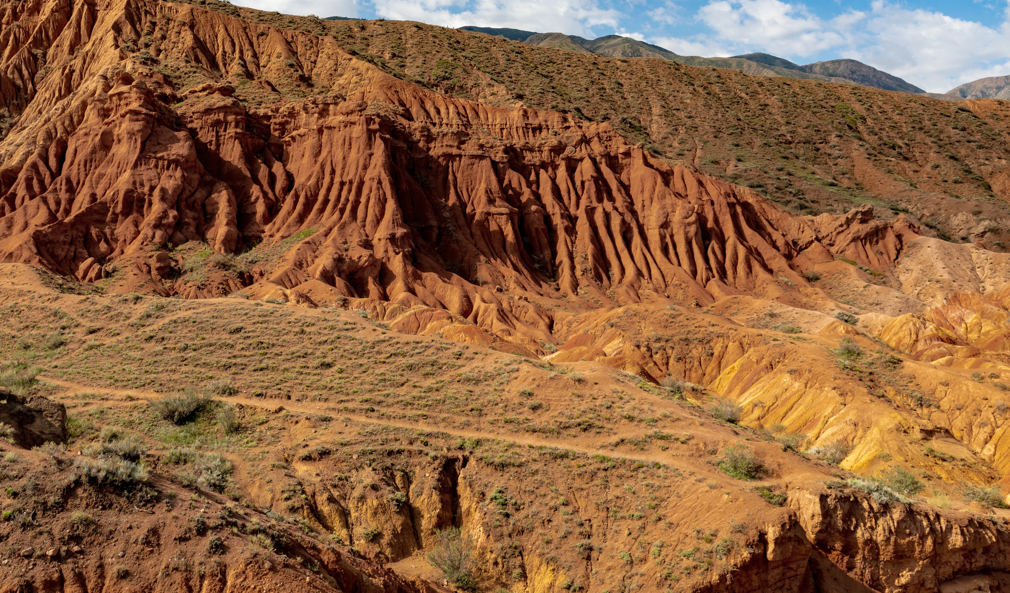 Red and ochre rock formations in Skazka (Fairytale) Canyon.